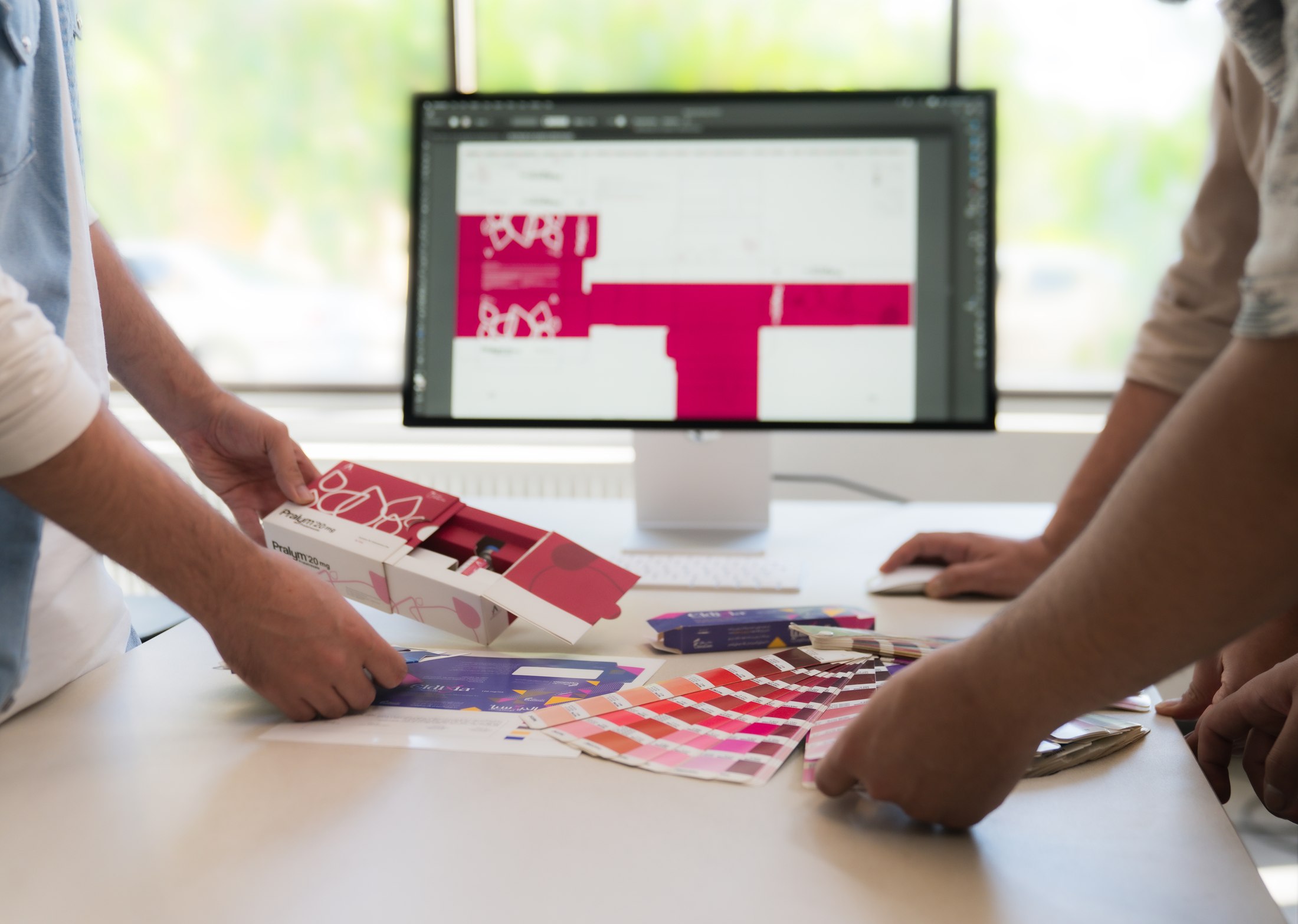 Quality control team reviewing print